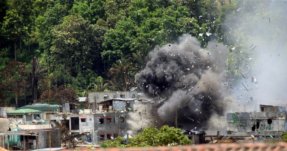 Debris and smoke are seen after an OV-10 Bronco aircraft released a bomb during an airstrike, as government forces continue their assault against insurgents from the Maute group, who have taken over large parts of Marawi City on Tuesday. (Reuters)