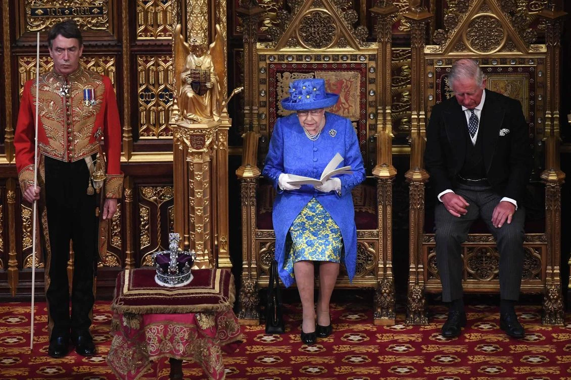 Britain’s Queen Elizabeth II sits alongside her son Britain’s Prince Charles, Prince of Wales as she delivers the Queen’s Speech during the State Opening of Parliament in the Houses of Parliament in London. (AFP)