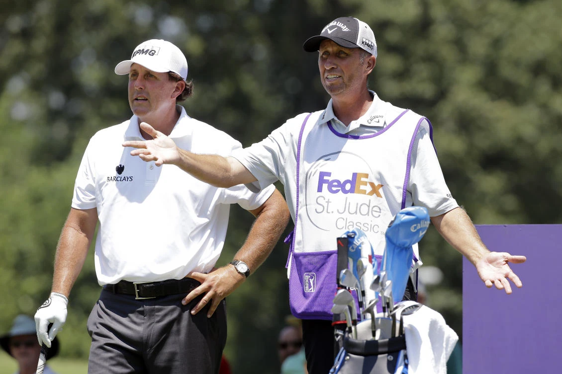 In this June 11, 2015, file photo, Phil Mickelson, left, talks with his caddie Jim Mackay on the eighth tee during the first round of the St. Jude Classic golf tournament in Memphis, Tenn. (AP)