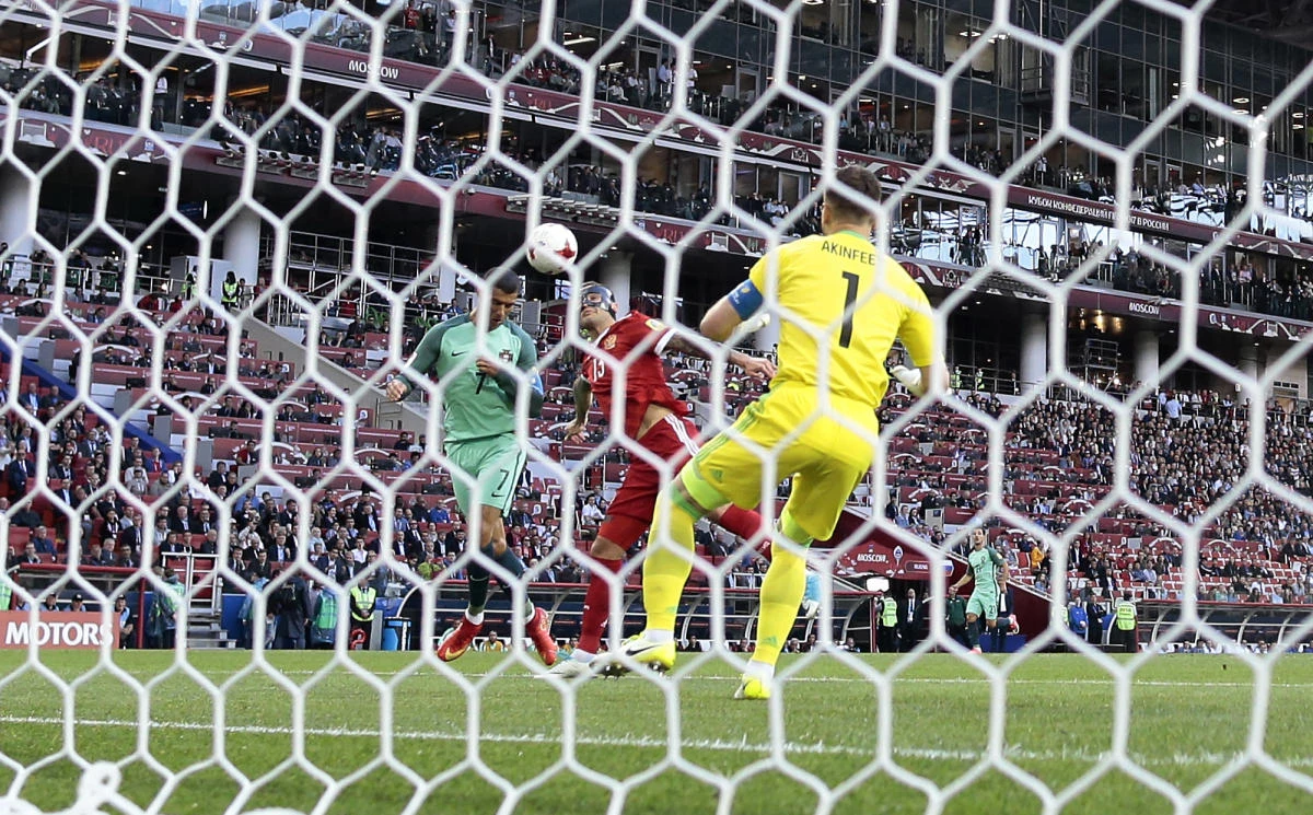 Portugal's Cristiano Ronaldo, left, scores a goal with a header during the Confederations Cup Group A soccer match between Russia and Portugal, at the Spartak Stadium in Moscow, Wednesday. (AP)