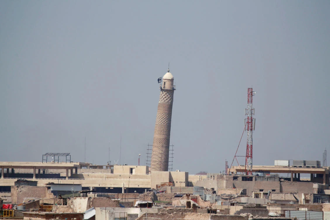 A flag of Daesh militants is seen on top of Mosul’s Al-Hadba minaret at the Grand Mosque, where Daesh leader Abu Bakr Al-Baghdadi declared his caliphate back in 2014, during clashes between Iraqi forces and Daesh militants in Mosul, Iraq. Picture taken March 24, 2017. (REUTERS)