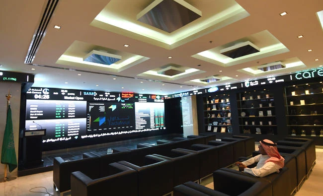 In this file photo, A Saudi investor monitors the stock exchange at the Saudi Stock Exchange in Riyadh. (AFP)