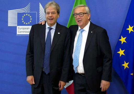 Italian prime minister Paolo Gentiloni (L) is greeted by European Commission President Jean-Claude Juncker prior to a meeting at EU headquarter in Brussels on Thursday, June 22, 2017. (AP)