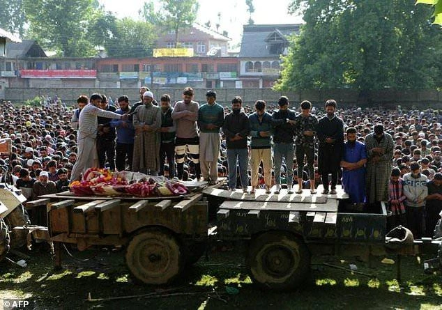 Thousands of villagers poured onto the streets of Kashmir for the funeral of three rebels who were killed overnight in clashes with soldiers. (AFP)