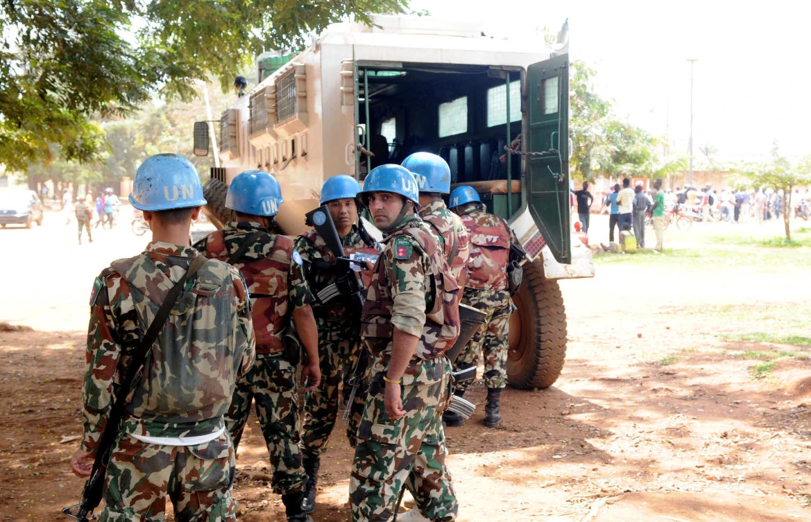 Peacekeepers from The United Nations Organization Stabilization Mission in the Democratic Republic of the Congo (MONUSCO) stand near their armoured personnel carrier (APC) after a clash between the army and militia fighters in Beni, eastern Democratic Republic of the Congo. (Reuters)
