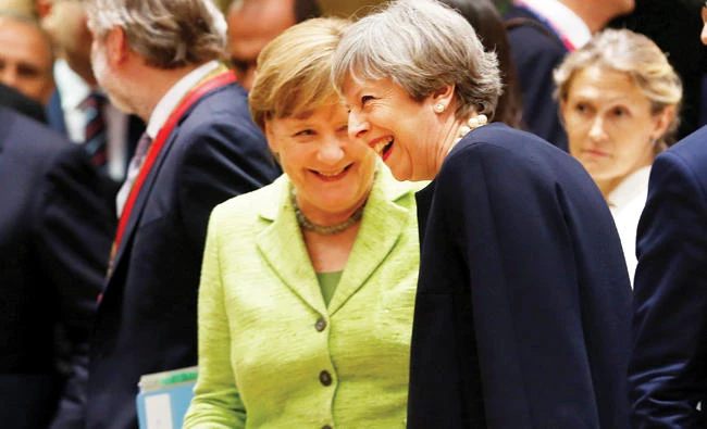 British Prime Minister Theresa May and German Chancellor Angela Merkel attend the EU summit in Brussels on Thursday. (Reuters)