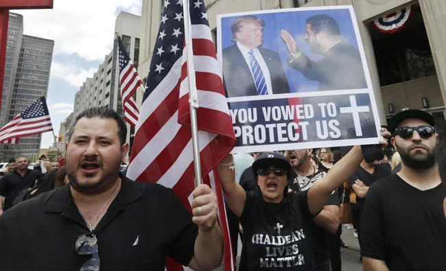 Iraqis and supporters rally outside the Theodore Levin United States Courthouse in Detroit, Michigan, on Wednesday. (AP Photo/Carlos Osorio)