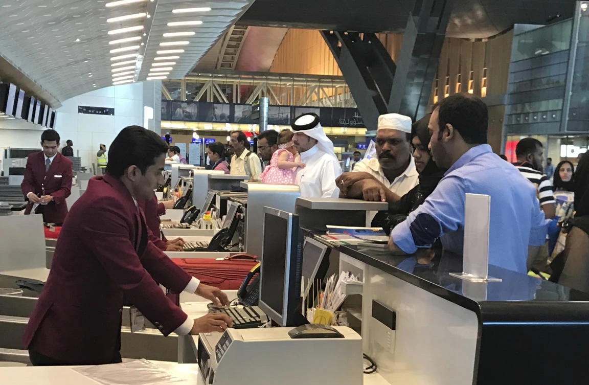 Qatari and other nationals queue at the check in counters of the Hamad International Airport in Doha, Qatar. (AP)
