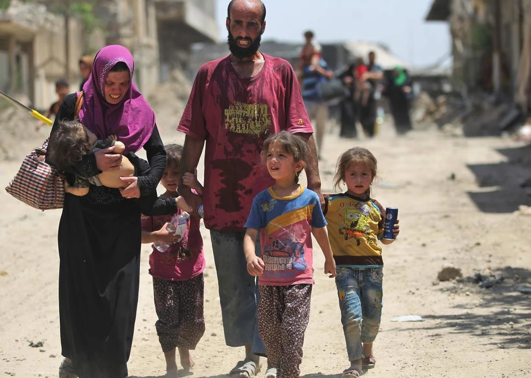 An Iraqi family flees from the Old City of Mosul, during the ongoing offensive by Iraqi forces to retake the last district still held by the Daesh group. (AFP)