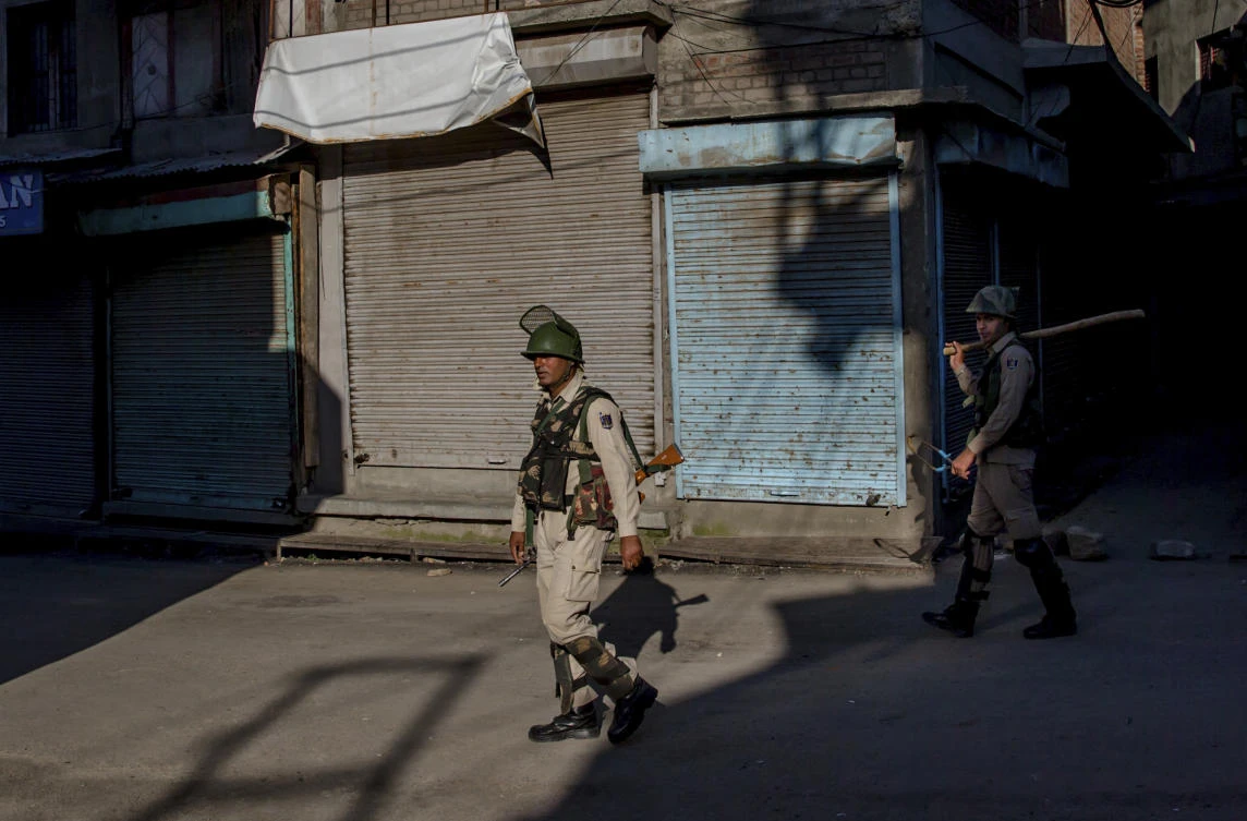 Indian paramilitary soldiers patrol during curfew in downtown area of Srinagar, Indian controlled Kashmir, Friday, June 23, 2017. (AP Photo/Dar Yasin)