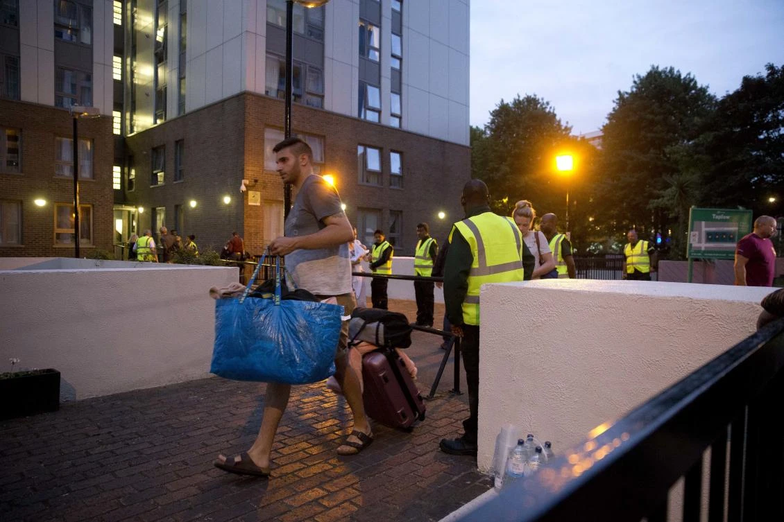 Residents are evacuated from the Taplow residential tower block on the Chalcots Estate, in the borough of Camden, north London, on Friday. (AP Photo/Alastair Grant)