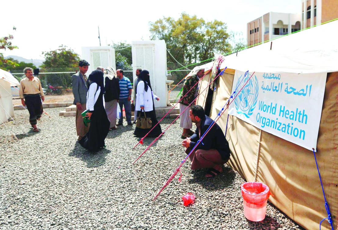 Yemenis wait outside a tent where patients infected with cholera are receiving treatment at Sabaeen Hospital in Sanaa. (AFP)
