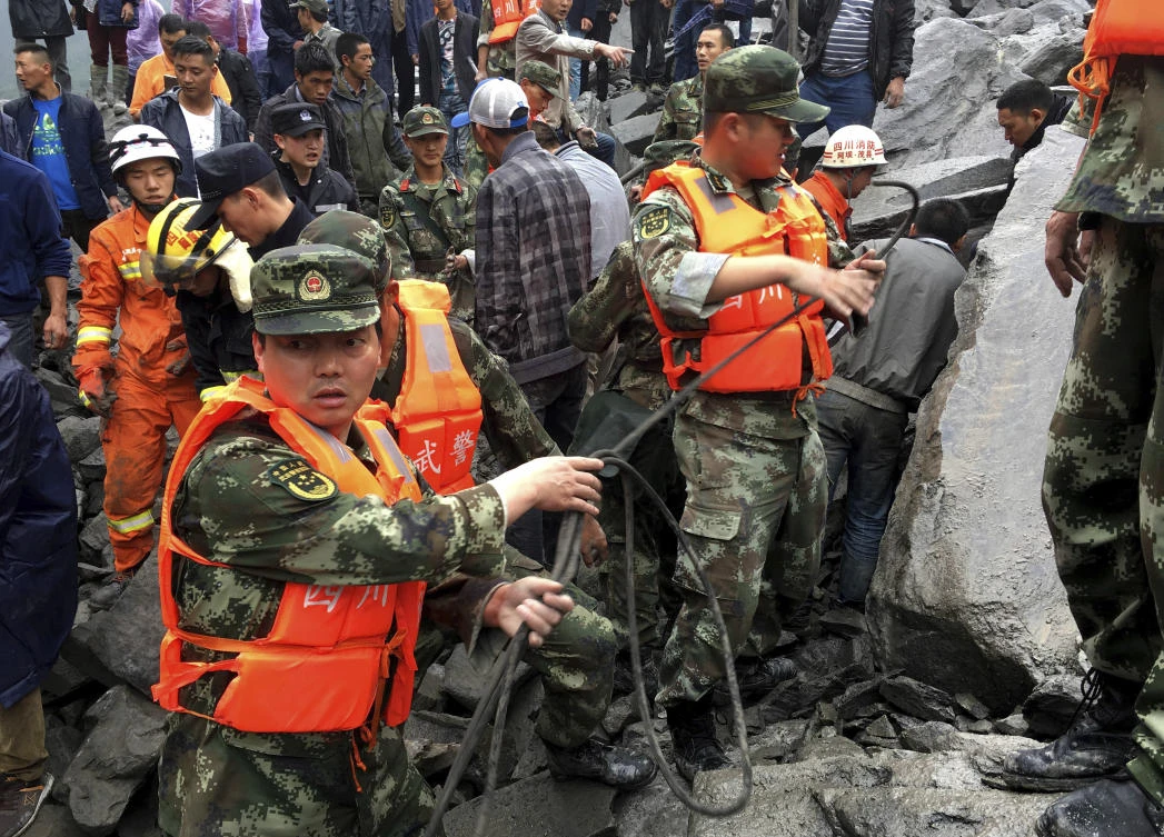 Emergency personnel work at the site of a massive landslide in Xinmo village in Maoxian County in southwestern China's Sichuan Province, Saturday, June 24, 2017. Dozens of people are feared buried by a landslide that unleashed huge rocks and a mass of earth that crashed into their homes in southwestern China early Saturday, a county government said.(AP)