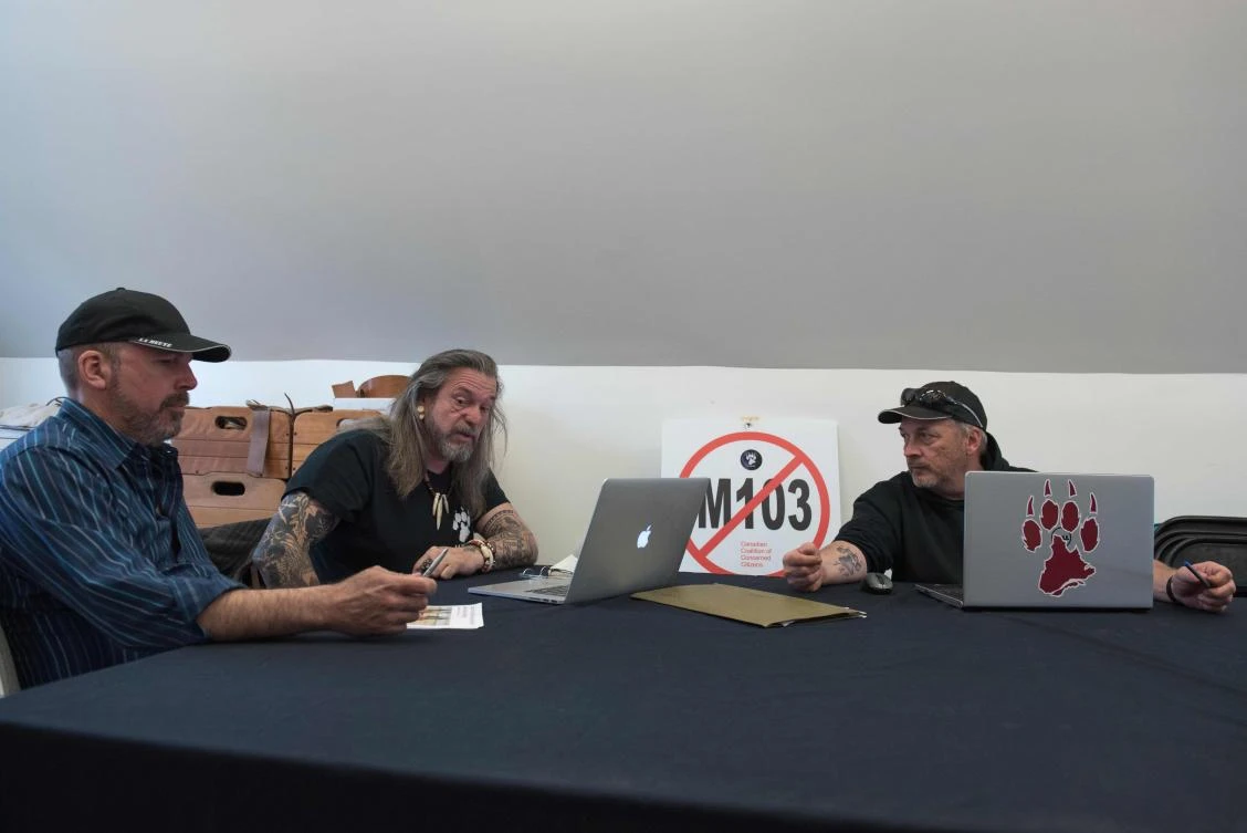 Stephane Brouillette, left, Patrick Beaudry, center, and Eric Proulx during a meeting of the La Meute in Stoneham-et-Tewkesbury, Quebec. (AFP)
