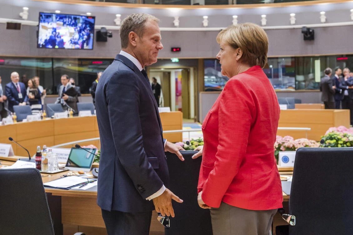 German Chancellor Angela Merkel, right, speaks with European Council President Donald Tusk during a round table meeting at an EU Summit in Brussels on Friday, June 23, 2017. (AP)