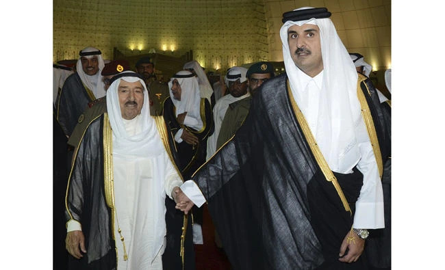 In this June 7, 2017 file photo released by Kuwait News Agency (KUNA) Kuwait's Emir Sheikh Sabah Al Ahmad Al Sabah, left, holds the hand of Qatar's Emir Sheikh Tamim bin Hamad Al Thani in Doha as he begins his mission to mediate between Qatar and the four Arab nations that cut ties with it. On Saturday, UAE's top diplomat said the four Arab nations don’t want European mediation. (KUNA via AP, File)