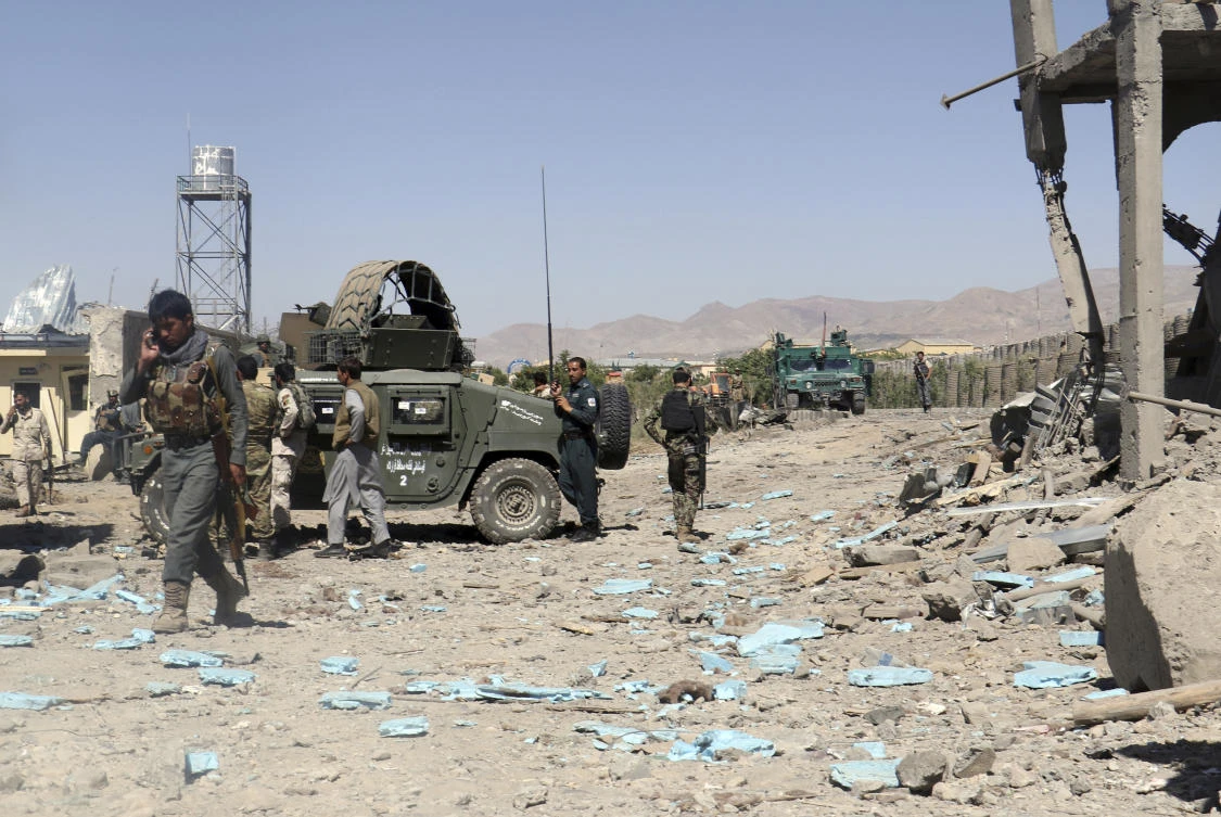 FILE - In this Sunday, June. 18, 2017, file photo, security forces are deployed to the site of a suicide attack between Taliban insurgents and government forces near the main police station in eastern Paktia province, Afghanistan. In a message ahead of the Muslim holiday of Eid al Fitr, the Afghanistan Taliban leader, Maulvi Haibatullah Akhunzada Friday said a planned U.S. troop surge would not end the protracted war, vowing to fight on until a full withdrawal of NATO troops. (AP)