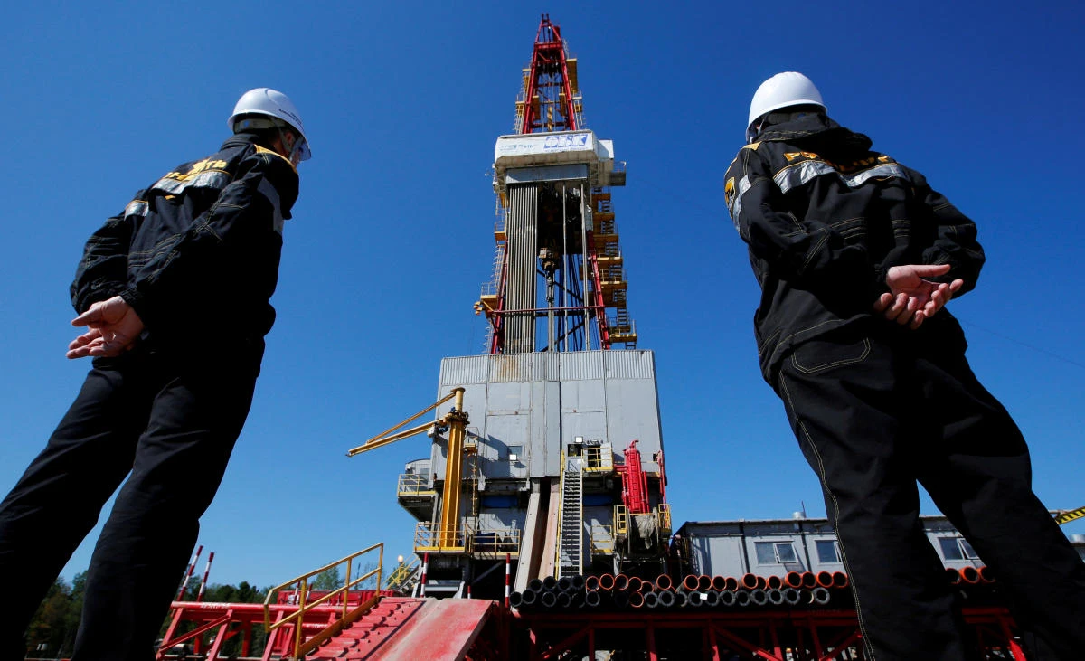 Workers look at a drilling rig at the Prirazlomnoye oil field outside the West Siberian city of Nefteyugansk, Russia. (Reuters)