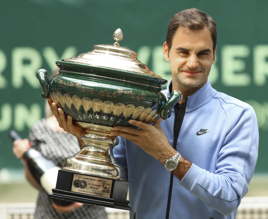 Switzerland's Roger Federer celebrates his victory after the final match against Germany's Alexander Zverev at the Gerry Weber Open tennis tournament in Halle, Germany, Sunday. Federer defeated Zverev in two sets for his ninth title in the tournament. (AP)