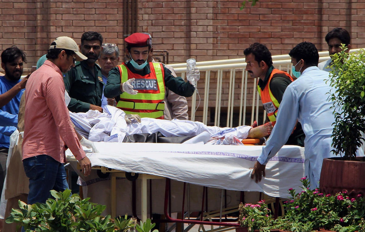 Pakistani rescue worker and hospital staff transport a victim of an oil tanker explosion at a hospital in Multan, Pakistan, Sunday, June 25, 2017. An overturned oil tanker burst into flames in Pakistan on Sunday, killing scores of people who had rushed to the scene of the highway accident to gather leaking fuel, an official said. (AP)