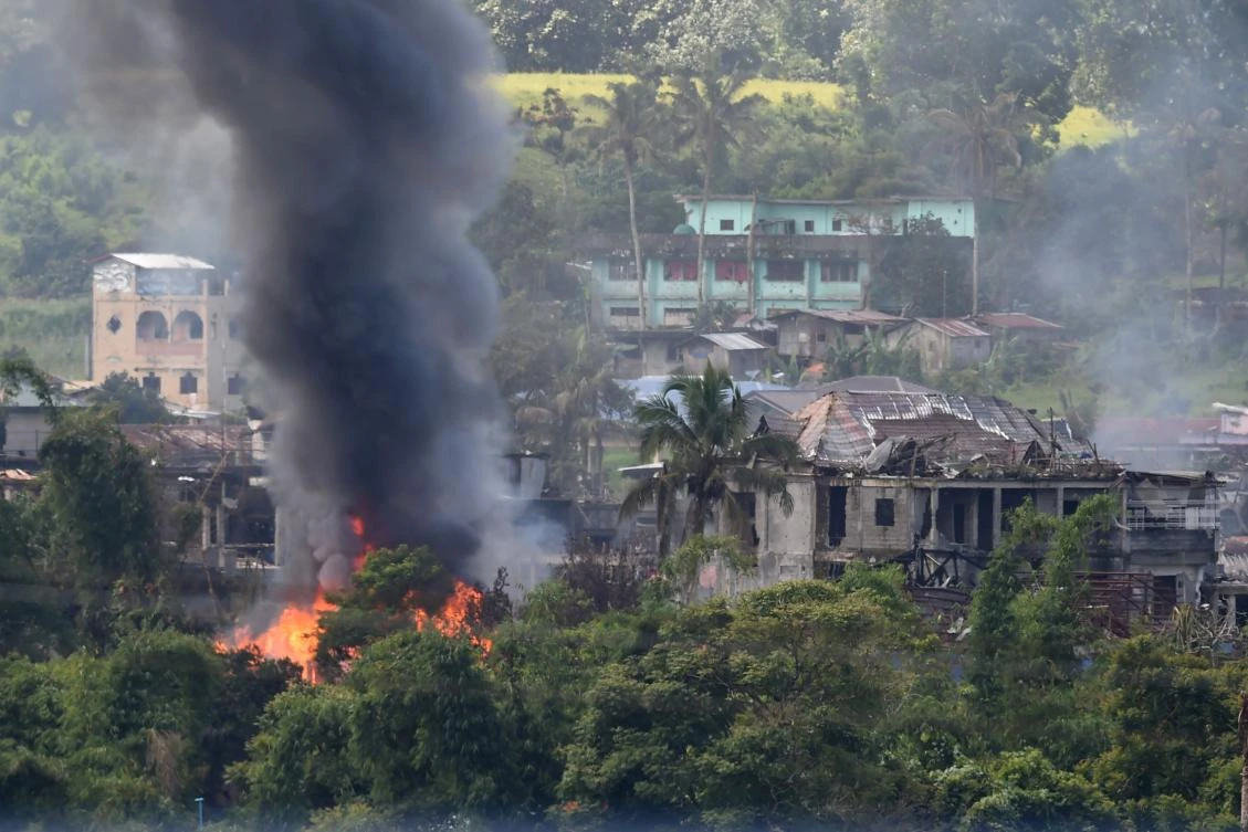 Black smoke billows from burning houses after Philippine Air Force attack planes conducted aerial bombings on militants' positions in Marawi on the southern island of Mindanao on Monday. (AFP)