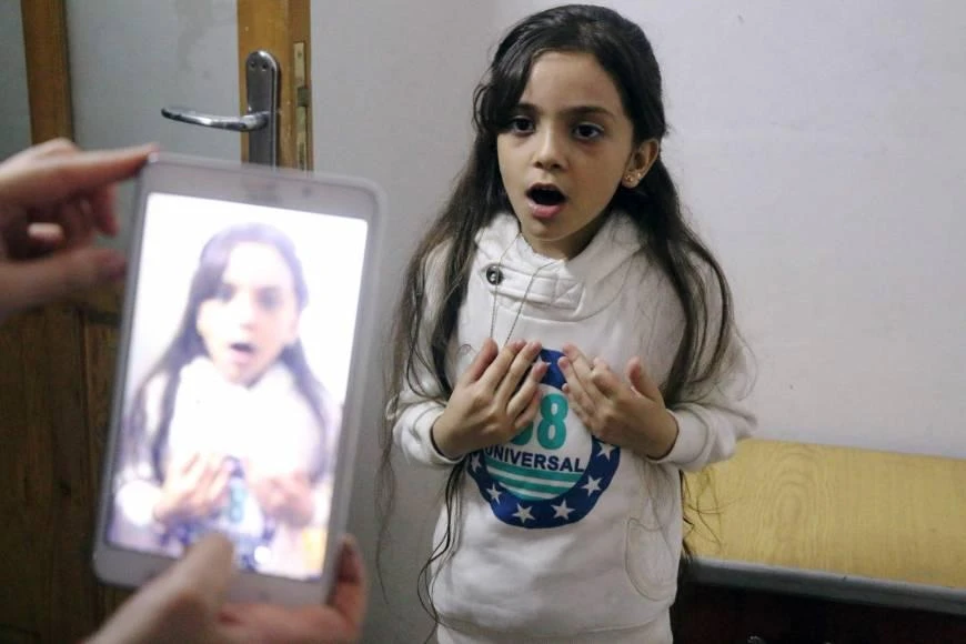 Bana al-Abed is filmed by her mother on Oct. 12 as they prepare to post on Twitter in English about life in the besieged eastern districts of Aleppo, Syria. (AFP)