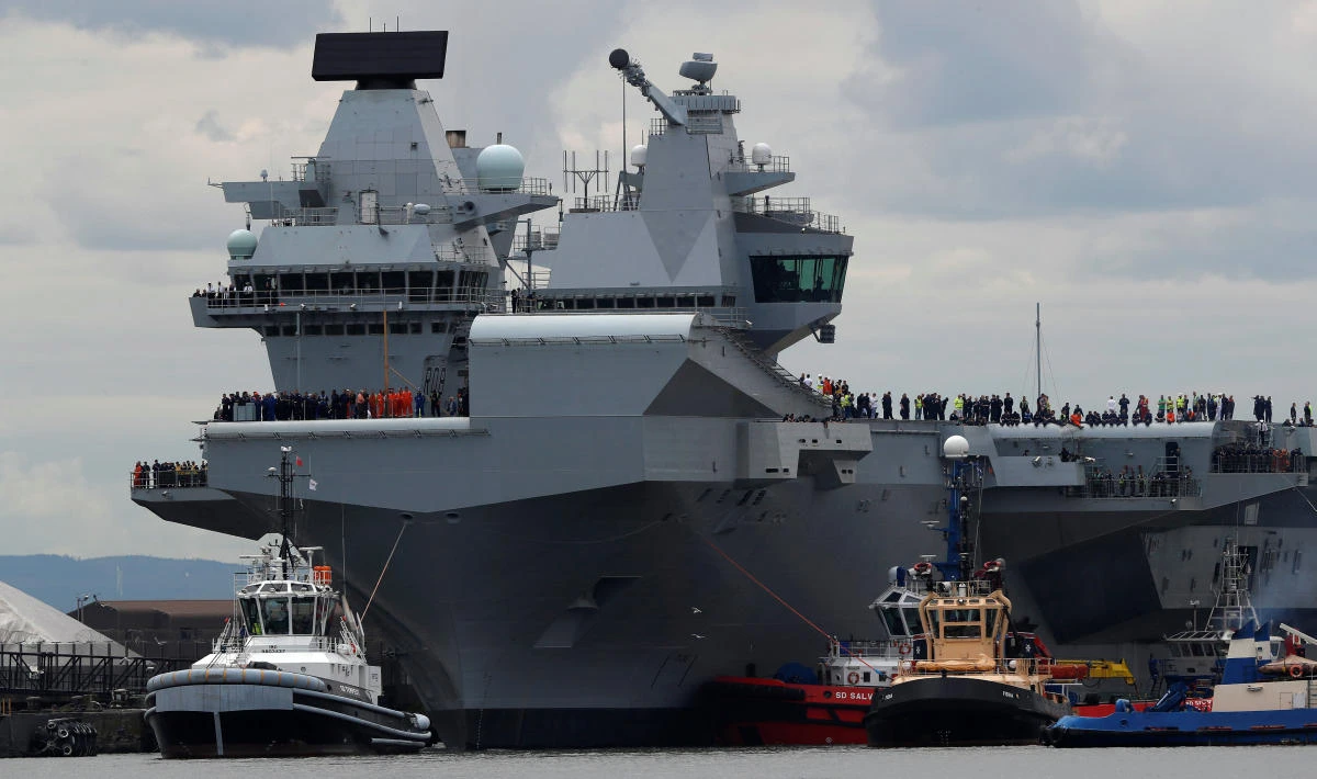 The British aircraft carrier HMS Queen Elizabeth is pulled from its berth by tugs before its maiden voyage, in Rosyth, Scotland, Britain June 26, 2017. (REUTERS)