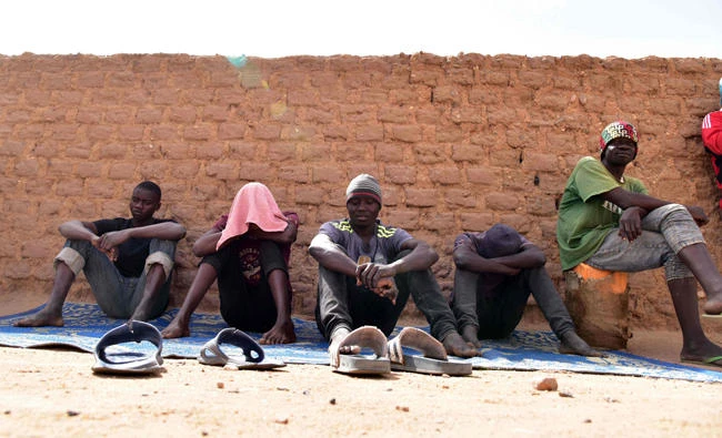 In this file photo, migrants from West Africa waiting in a room at a "ghetto" in Agadez, northern Niger. (AFP)