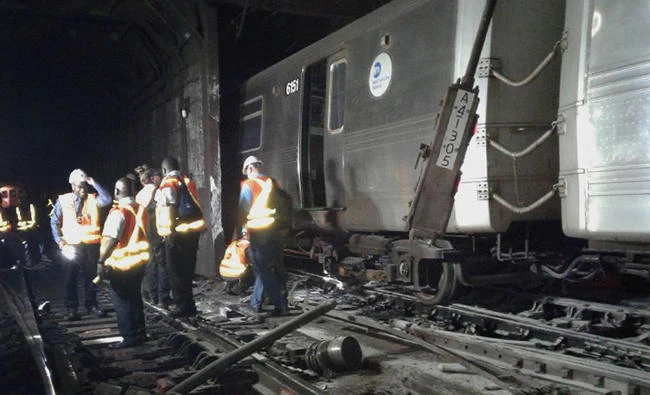 In this photo provided by the Transport Workers Union, Local 100, workers from the New York Metropolitan Transportation Authority examine damaged train tracks, at the scene of a subway derailment on Tuesday in New York. (Transport Workers Union, Local 100 via AP)