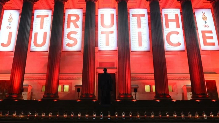 Candles light up the entrance to St George's Hall in Liverpool after the verdict. (AFP)