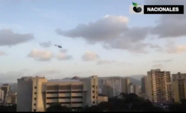 In this photo taken from a video, A police helicopter flies over Venezuela's Supreme Court building in Caracas on June 27, 2017. (Reuters)