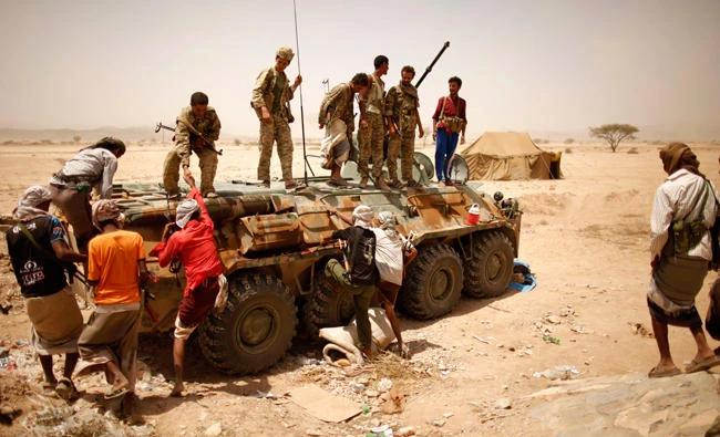 Yemen militia climb a military vehicle to join members of government troops chasing Al-Qaeda militants near the Saudi border in this file photo. (AFP)