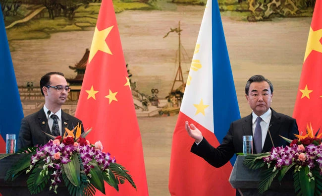 Philippines Alan Peter Cayetano, left, and China's Wang Yi hold a press conference in Beijing on Thursday. (AFP)