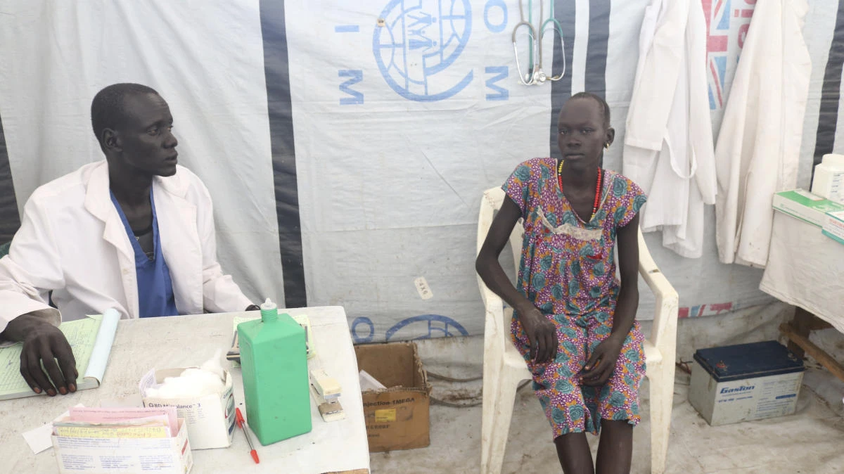 Lab technician James Khor, treats a patient at his private clinic, which is right across from the cholera center set up by Doctors Without Borders in Pieri South Sudan last Tuesday.(AP)