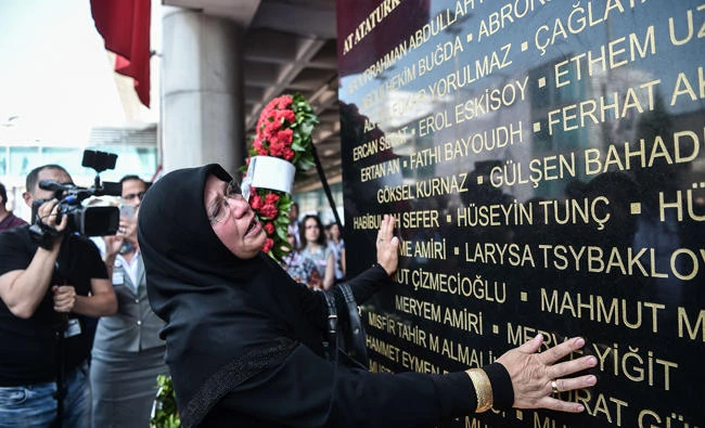 A woman reacts as relatives of victims attend a memorial cerenomy on Wedensday at Ataturk International airport in Istanbul. (AFP)