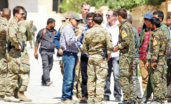 Brett McGurk, US special envoy for the coalition against Daesh, arrives for a meeting with the Tabqa Civil Council in Tabqa, 55 km from Raqqa. (AFP)