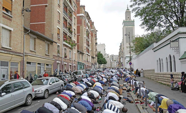Muslims offer Eid al-Fitr prayers outside the Grande Mosquee de Paris (Great Mosque of Paris) in Paris on June 25, 2017. French police on Thursday arrested a man who tried to drive a car into a crowd in front of a mosque in the Paris suburb of Creteil.(AFP / Zakaria Abdelkai/file)