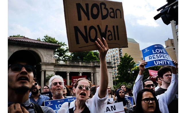 Recent Immigrants join activists for an evening protest in Manhattan hours before a revised version of President Donald Trump's travel ban that was approved by the Supreme Court is to take effect on Thursday in New York City. (Spencer Platt/Getty Images/AFP)