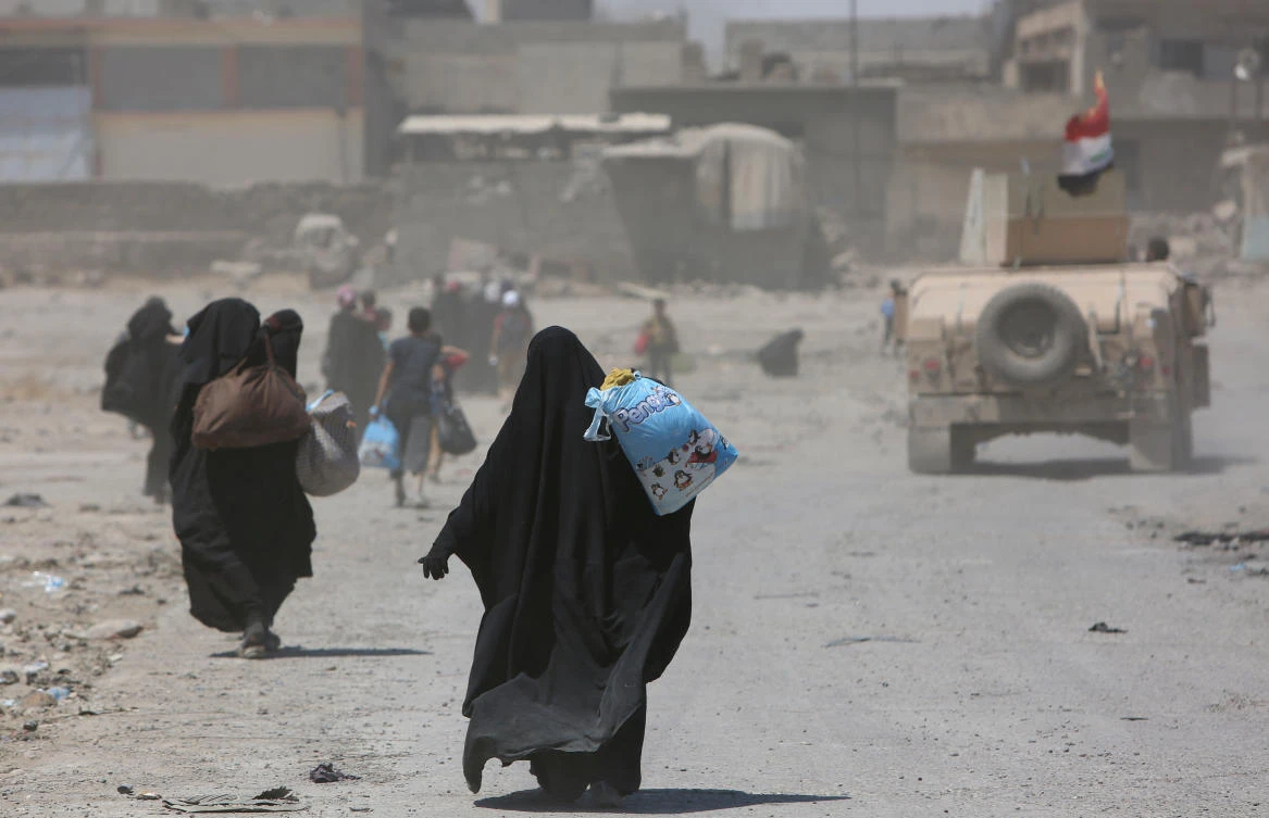 Displaced Iraqi civilians are escorted out of Mosul’s Old City by Iraqi security forces during fighting between Iraqi security forces and Daesh militants in Mosul, Iraq (REUTERS)