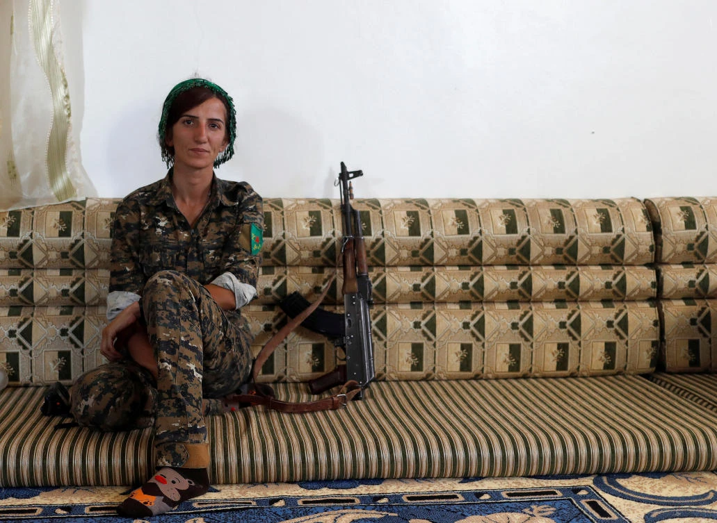 Sheen Ibrahim, Kurdish fighter from the People's Protection Units (YPG) sits inside a house in Raqqa, Syria. (Reuters)