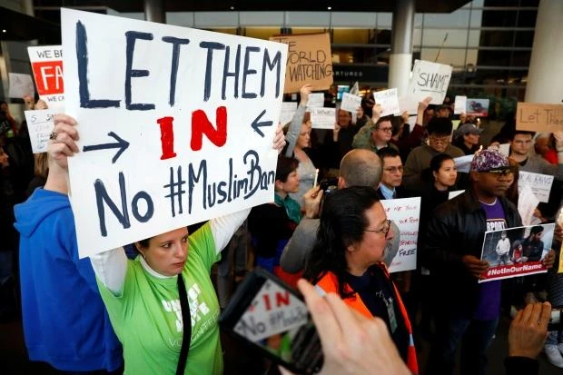 At the Los Angeles International Airport, people protest U.S. President Donald Trump's sweeping executive order barring refugees and travellers from seven Muslim-majority countries. Canada says its citizens will not be affected. (Reuters)
