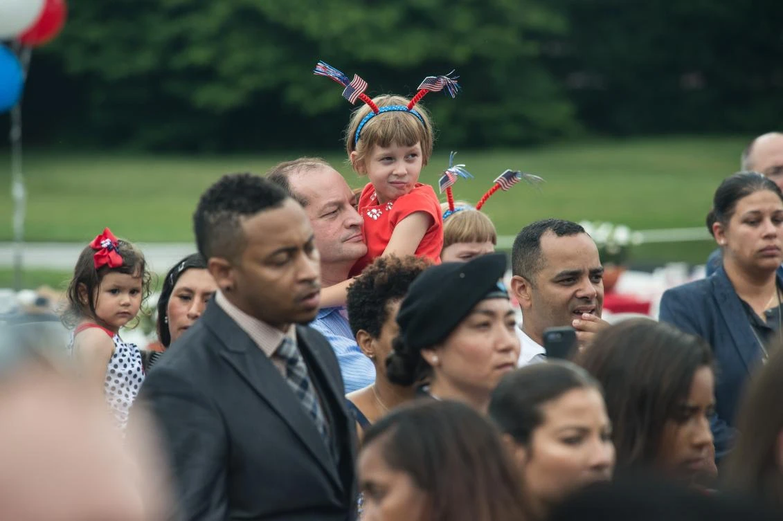 People listen to US President Donald Trump speak during the military families picnic at the White House in Washington, DC, on July 4, 2017. / AFP / NICHOLAS KAMM