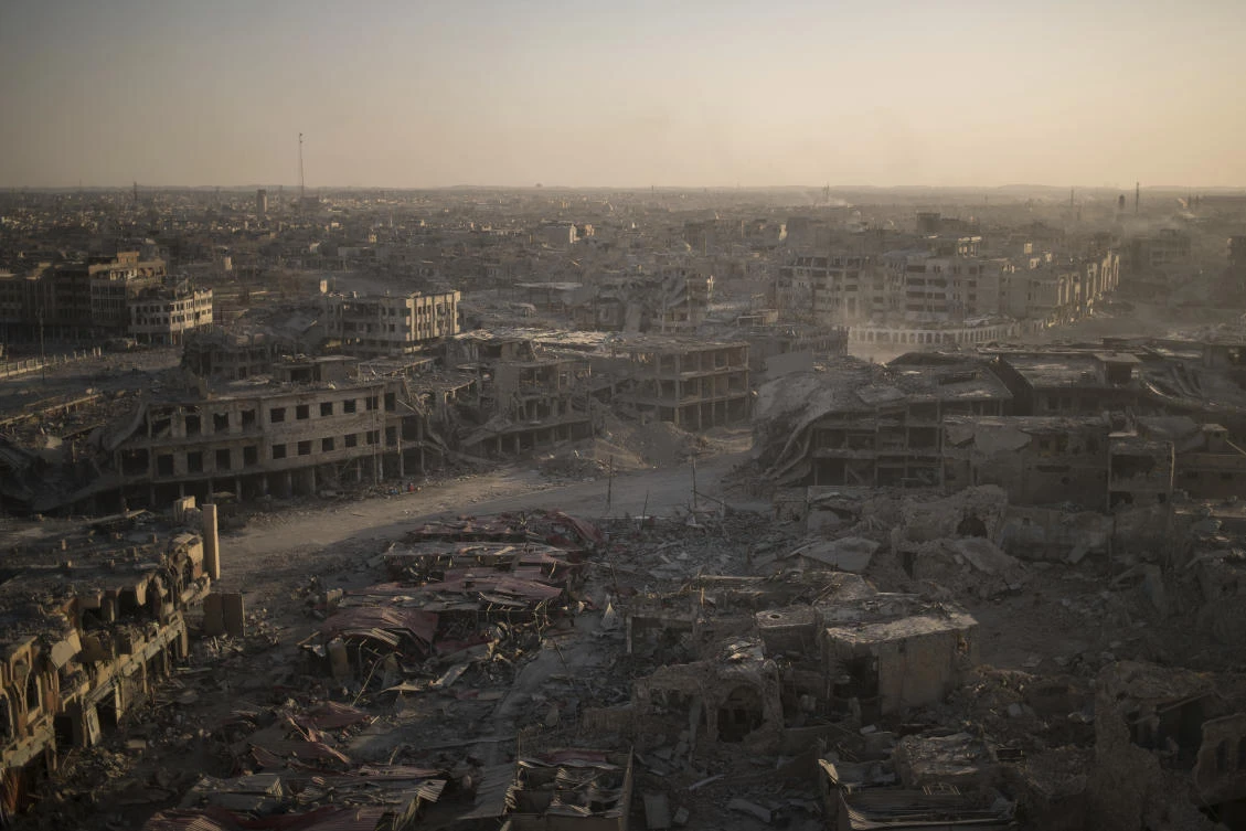 In this July 11, 2017 photo, damaged buildings are lit by the setting sun on the west side of Mosul, Iraq. Iraq’s U.S.-backed forces succeeded in wresting Mosul from the Islamic State group but at the cost of enormous destruction. The nearly 9-month fight culminated in a crescendo of devastation _ the blasting of the historic Old City to root out the militants’ final pockets. (AP Photo/Felipe Dana)