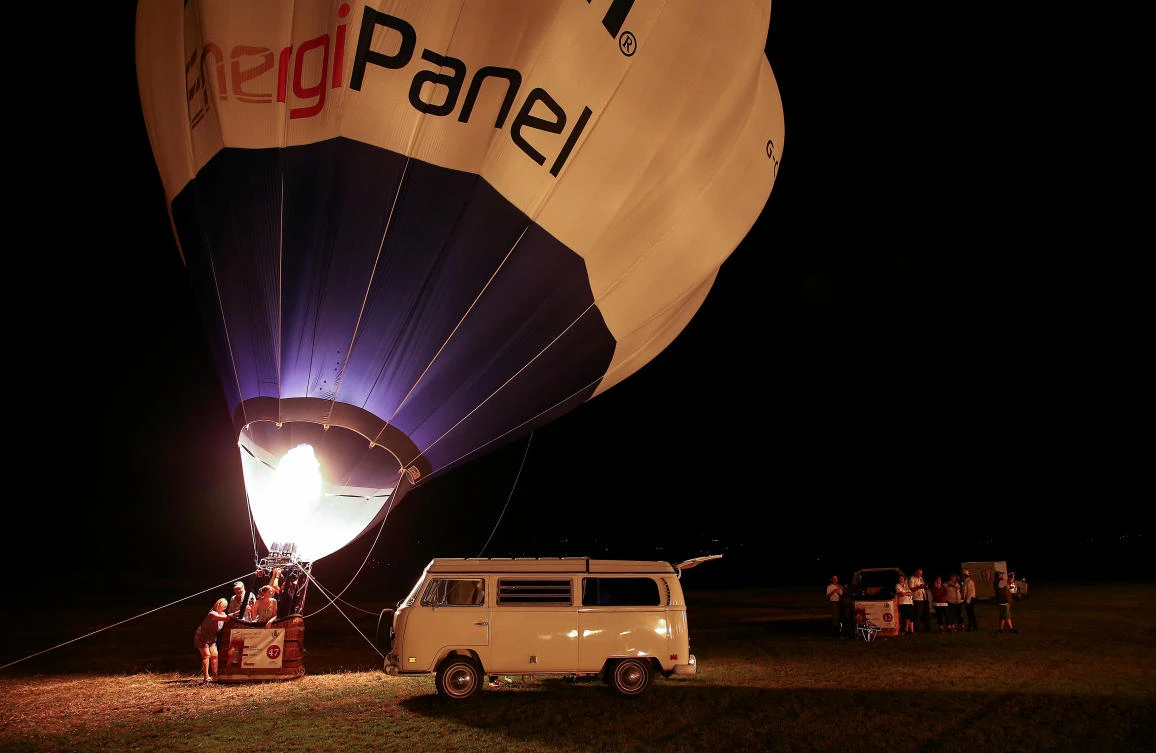 Crew members fire up their hot air balloon during an Italian hot air ballooning event in Terni, Italy, July 28, 2017. REUTERS/Alessandro Bianchi