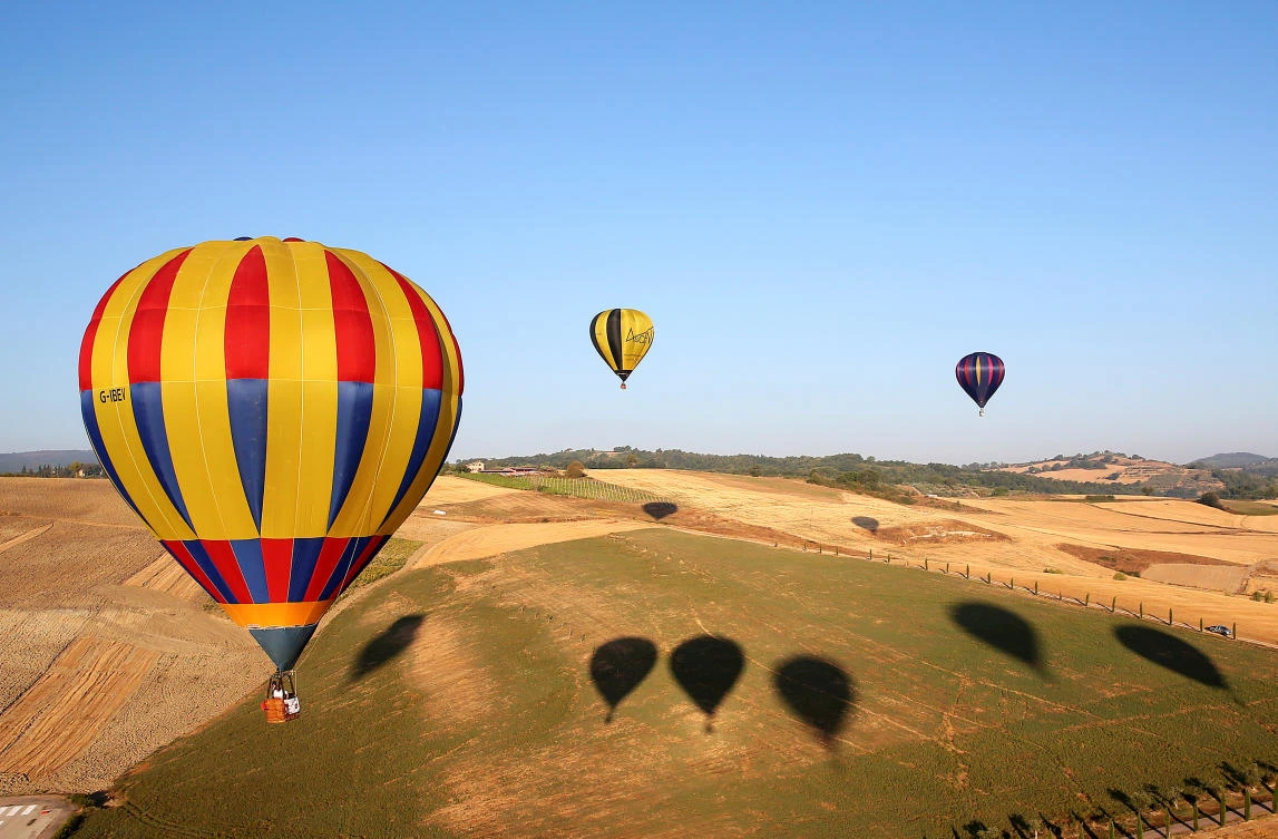 Hot air balloons fly during a hot air ballooning event in Todi, Italy, July 29, 2017. REUTERS/Alessandro Bianchi