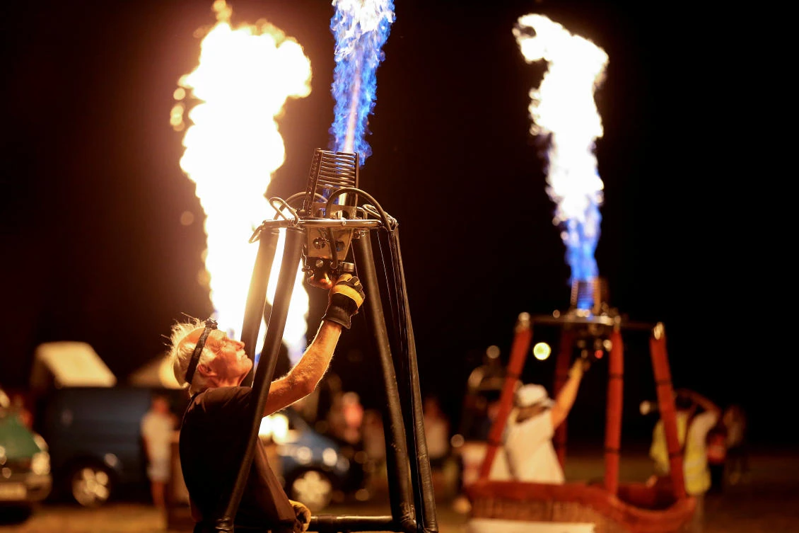 A man fires up his hot air balloon during an Italian hot air ballooning event in Terni, Italy, July 28, 2017. REUTERS/Alessandro Bianchi