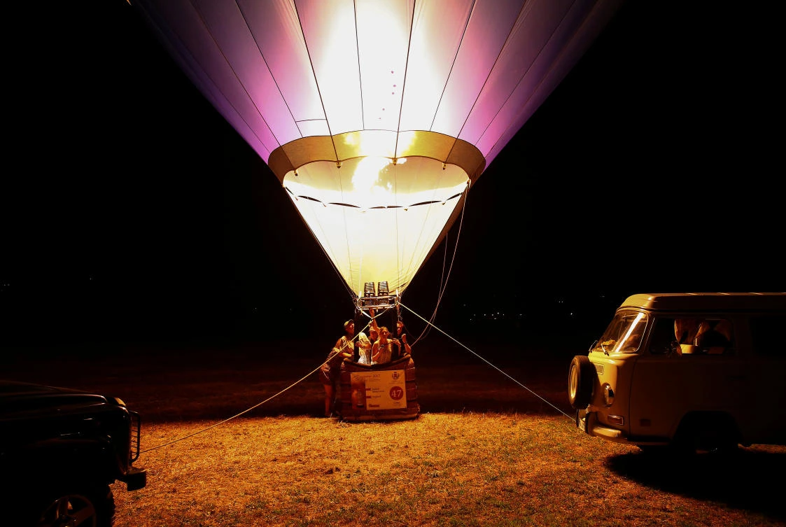 Crew members fire up their hot air balloon during an Italian hot air ballooning event in Terni, Italy, July 28, 2017. REUTERS/Alessandro Bianchi