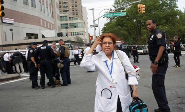 Hospital employees exit Bronx-Lebanon Hospital Center on Friday in the Bronx borough of New York city after a former hospital employee shot and killed one and injured at least six other people before gunning himself down with an assault rifle. (Yana Paskova/Getty Images/AFP)