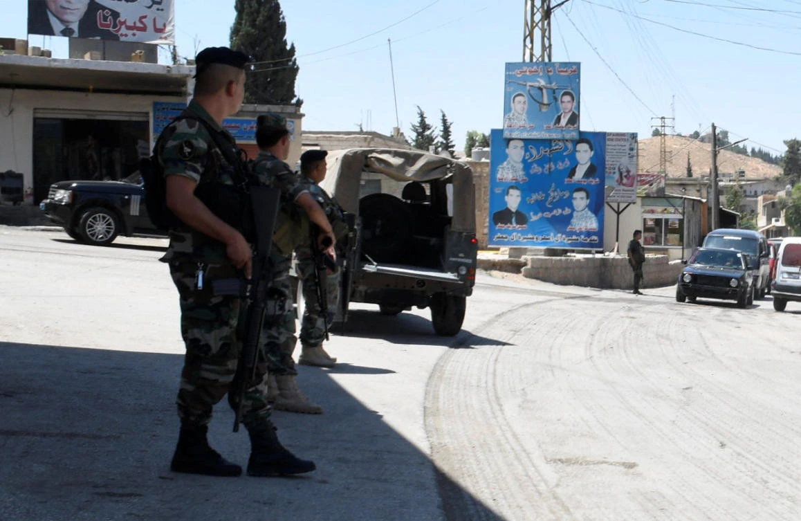 Lebanese army soldiers patrol a street at the entrance of the border town of Arsal, in eastern Bekaa Valley, Lebanon. (REUTERS)