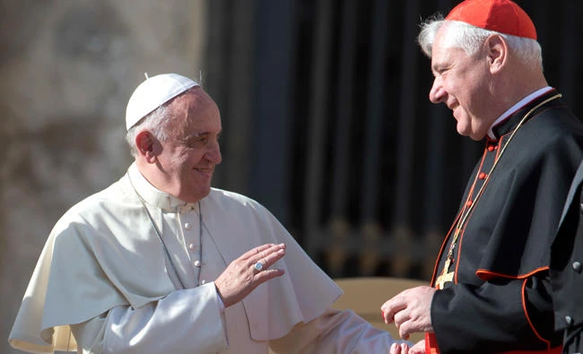 In this file photo, Pope Francis talks with Cardinal Gerhard Ludwig Mueller in St. Peter's Square at the Vatican. (AP)